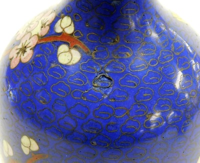 A pair of Chinese cloissone vases, of baluster form with a flared rim, each decorated with birds and flowers on a blue ground, 15cm high. (AF) - 8