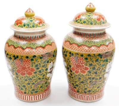 A pair of Chinese porcelain baluster jar and covers, decorated with boys clambering among scrolling peonies, six character Kangxi mark to underside, 41cm high. - 3