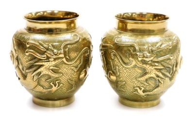 A pair of 20thC polished brass Chinese vases, with raised dragon decoration, 14cm high.