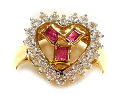 A heart shaped diamond and ruby pierced cluster ring, set in a hand carved precious yellow metal mount and shank, twenty diamonds of average 1.5mm approx, varied colour saturation and one stone is chipped, 6.14g all in, size Q.