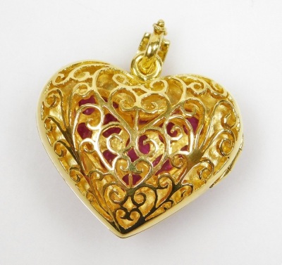 A heart shaped faceted ruby set pierced vinaigrette style locket, pierced back and faceted ruby set front hinged to open, set with thirty two generally oval shaped faceted rubies ranging from 4.8mm x 3.2mm to 2.1mm x 1.5mm approx, millegrain set in precio - 3