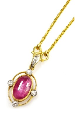 A cabachon ruby set pendant on chain, with diamond accents to the cardinal points with a tiny diamond set suspension loop, the cabachon ruby of 11.1mm x 6.7mm has rutile and other inclusions, all set in precious yellow metal, chain 36cm long, 10.4g all in