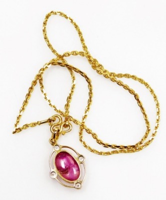 A cabachon ruby set pendant on chain, with diamond accents to the cardinal points with a tiny diamond set suspension loop, the cabachon ruby of 11.1mm x 6.7mm has rutile and other inclusions, all set in precious yellow metal, chain 36cm long, 10.4g all in - 3