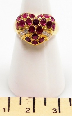 A heart shaped ruby and diamond set ring, the head set with nineteen oval faceted stones with six tiny diamonds to the sides, rubies average 2mm x 1mm, all set in precious yellow metal, 6g all in, size N. - 2