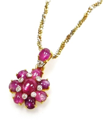 A floral pendant on chain, set with cabachon rutile filled rubies and tiny diamonds on a cabachon ruby and diamond set suspension loop to a bi-colour precious metal chain, 42cm long, 11.2g all in.