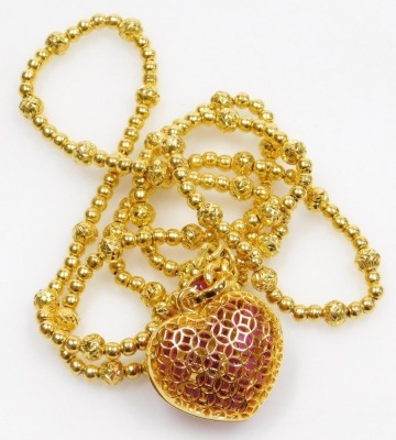 A heart shaped ruby set pendant on heavy bead necklace, the pierced heart locket set with variously shaped stones to ruby set suspension loop on a beaded necklace, the whole in precious yellow metal, 62cm long, 41g all in. - 3