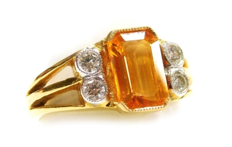 A yellow stone and diamond set dress ring, the central stone (possibly topaz) of 8.4mm x 5.8mm set with pairs of small diamonds either side, 2mm diameter, in yellow precious metal, 5.2g all in, size K.