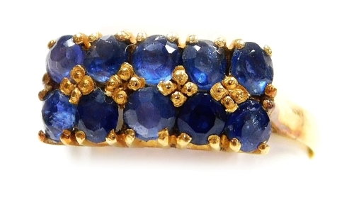 A double row sapphire set dress ring, two rows of five mine cut sapphires, set in precious yellow metal, size K, 2.8g all in.