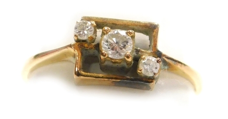 A diamond set dress ring, three small diamonds set diagonally within a square frame, central stone of 2mm diameter, set in precious yellow metal, 1.48g all in.