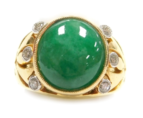 A jade and diamond set dress ring, the cabachon central stone of 12mm x 10.5mm with three small round diamonds each side to pierced shoulders, all in precious yellow metal, size K½, 10.28g all in.