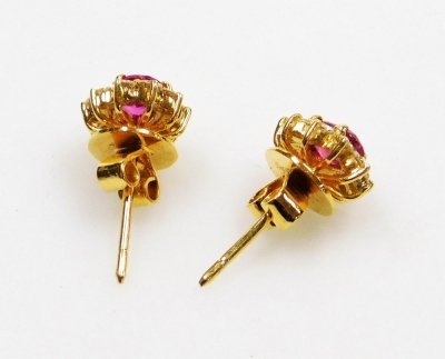 A pair of ruby and diamond cluster earrings, the central facet cut ruby of 6.1mm x 5.2mm surrounded by ten round brilliant cut diamonds of 1.5mm diameter average, post and butterfly backs, set in precious yellow metal, 5.1g all in. - 3