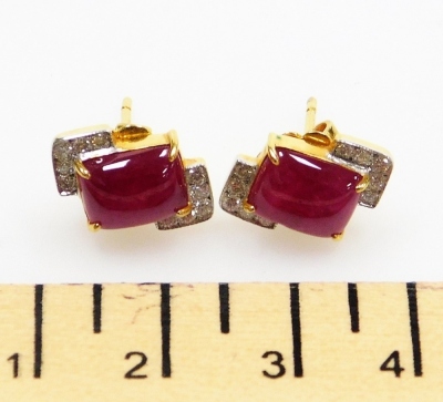 A pair of cushion cabachon ruby and diamond earrings, the central rectangular ruby of 8.7mm x 7mm edged by two diamond set corners, each of five tiny diamonds, 1.7mm x 7.8mm each approx, post and butterfly backs, set in precious yellow metal, 5.5g all in. - 2