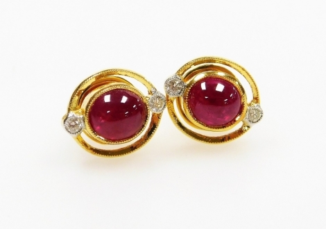 A pair of cabachon ruby and diamond set earrings, the central ruby of 4.8mm diameter, with tiny diamonds set north and south, post and butterfly back, 1.1cm x 0.9cm each, 3.5g all in.