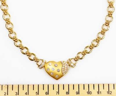 A heart shaped diamond set necklace, the central heart shape set with seven round brilliant cut diamonds of 2.3mm diameter average with a section set with tiny diamonds, four diamonds of 2mm diameter to each side liked to a heavy fancy chain, in precious - 2
