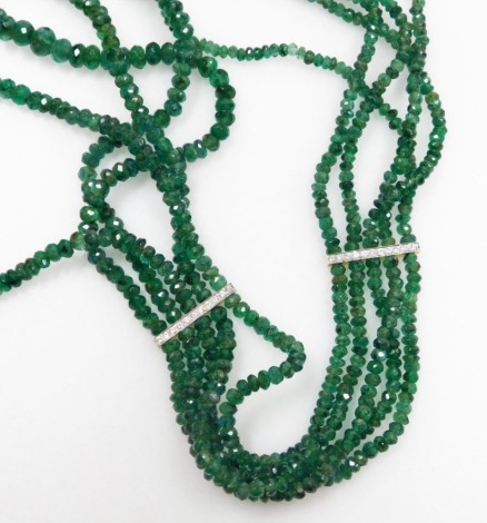 A rough faceted emerald bead multi strand necklace, five graduated strands of beads with four tiny white stone set spacers in white and yellow metal.