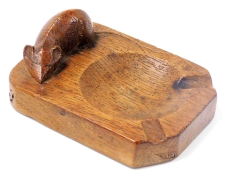 A Robert Thompson Mouseman oak ashtray, of rectangular shaped form with carved mouse, 10cm wide.