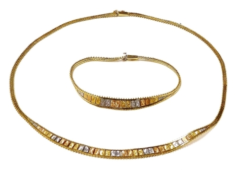 An 18ct three colour gold fringe necklace, together with a matching bracelet, each on a snap clasp, 24.3g.