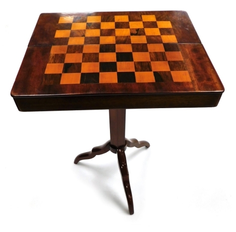 A Victorian mahogany campaign games table, with a rosewood and satinwood chess board top, the box opening to reveal a hexagonal table column and three folding tripod legs, 39cm wide, 16.5cm deep.