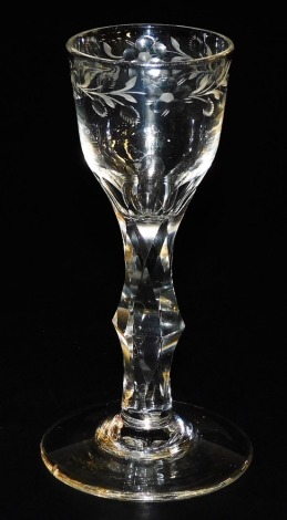 A late 18thC Georgian wine glass, the bowl engraved with a repeating floral and foliate pattern, raised on a faceted stem above a conical foot, 14cm high.