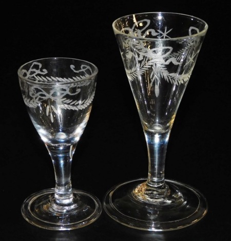 A late 18thC Georgian wine glass, of drawn trumpet form, engraved with tied swags and stars, raised on a plain stem and conical folded foot, 12cm high, together with a cordial glass, similarly decorated, 9.5cm high. (2)