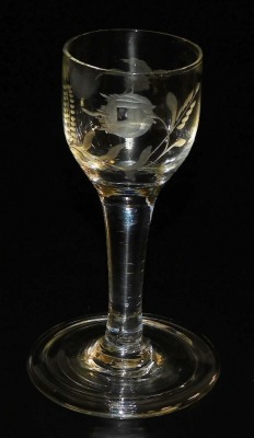 A late 18thC Georgian wine glass, the bowl engraved with bird and flower, alluding to Jacobite sympathies, raised on a straight stem and conical folding foot, 12cm high.