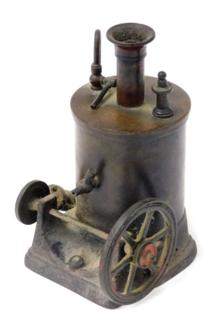 A late 19thC cast metal donkey engine, raised on an iron base, 15cm high.