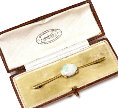 An Edwardian opal bar brooch, set in yellow metal, boxed for Lumbers Ltd of Leicester, 5.0g.