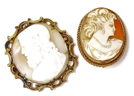 A 9ct gold and shell cameo brooch, bust portrait of a lady, in an oval frame, with safety chain as fitted, together with a Victorian cameo brooch, bust portrait of a Roman god, in a yellow metal gold frame. (2)