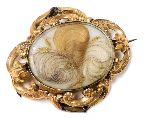 A Victorian hair locket mourning brooch, set in yellow metal, with pin and ring suspension, back engraved "Charles Collins Died Jan 16th 1852 Ob 64 Years - Isabella Outhwaite Died May 21st 1853 Aged 9 Months - Eliza. Th Collins Died February 16th 1855 Age