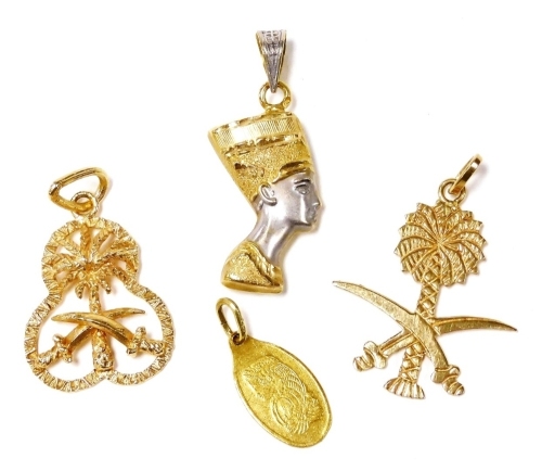 Two Saudi yellow metal emblematic pendants, 4.7g, a 1g fine gold pendant, and a bicolour yellow and white metal pendant modelled as Queen Nefertiti, 1.9g.