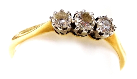 An 18ct gold and diamond three stone ring, high claw set, approx &#8531? ct, size T, 2.5g.