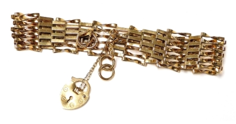 A 9ct gold six bar gate bracelet, on a heart shaped padlock clasp, with safety chain as fitted, 6.5g.