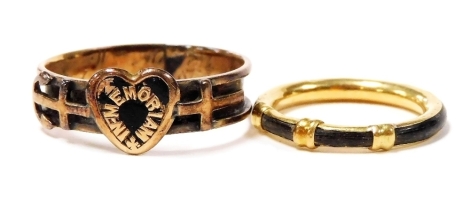 A Victorian yellow metal and black enamel memorial ring, the band decorated externally with a heart flanked by a cross and anchor, engraved internally to commemorate two deaths, size Q, together with a yellow metal and horn set band, size F/J.