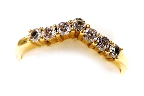 An 18ct gold and seven stone diamond wishbone eternity ring, approx &#8531?ct, size N/O, 3.2g.