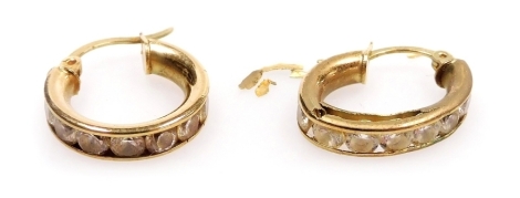 A pair of hoop earrings, channel set with white stones, stamped 9kt, 2.6g. (AF)