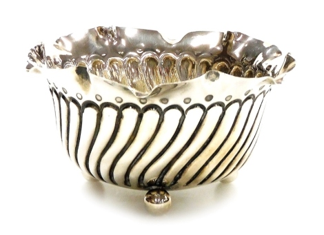 A Victorian silver bowl, with a shaped rim and an embossed fluted body, raised on three ball feet, George Bowen and Sons, Birmingham 1898, 2.54oz, 10.5cm wide.