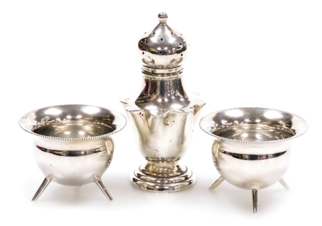 A pair of Edward VII silver open salts, each of cauldron form with a beaded rim, Mappin and Webb, Sheffield 1908, 3cm high, and a Victorian silver pepper pot, of shaped form on a stepped base, Sheffield 1897, 7.5cm high, 2.07oz.