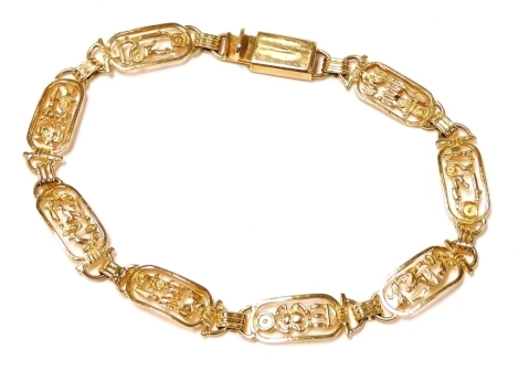 An Egyptian oval link bracelet, yellow metal, decorated with hieroglyphs on a snap clasp, 12.0g.