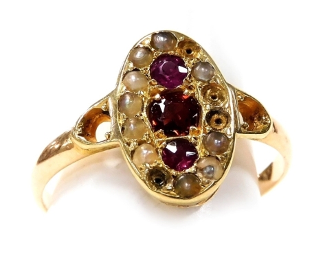 A Victorian garnet amethyst and seed pearl ring, in an oval cushion setting, in yellow metal, engraved to the shank internally 'Amelia from Will', size M, 2.3g.