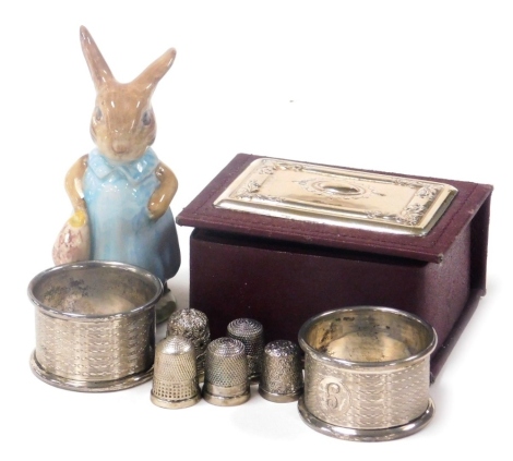 A group of small silver, comprising five thimbles, a pair of George V silver napkin rings, Birmingham 1922, jewellery box with silver inlay to lid containing costume jewellery, together with a Beswick Beatrix Potter Mrs Flopsy Bunny porcelain figure, 10cm