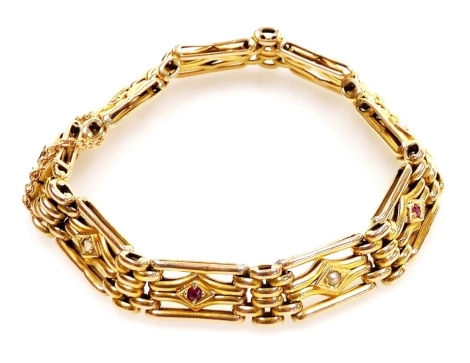 A 9ct gold fancy link gate bracelet, set with rubies and seed pearls at intervals, on a snap clasp, with safety chain as fitted, 13.4g.