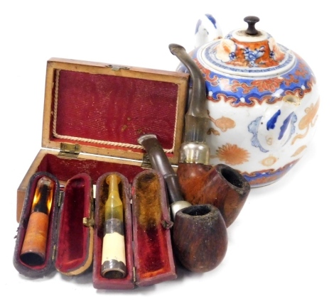 A late 19thC mauchline ware box, decorated to the lid with a view of Shanklin Chine, two meerschaum and amber cheroot holders, one with silver collar and mount, two Peterson's pipes, and a Qing dynasty Imari porcelain teapot. (6, AF)