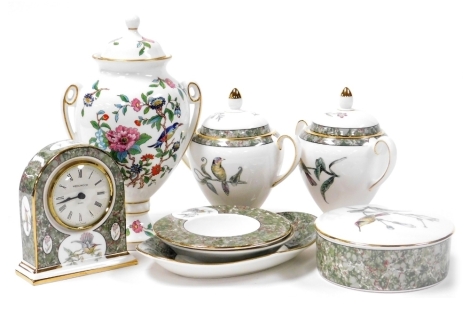 A group of Wedgwood porcelain decorated in the Hummingbirds pattern, including a mantel clock, powder box and cover, and two candle holders, together with an Aynsley porcelain vase and cover decorated in the Pembroke pattern. (8)