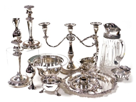 A group of plated wares, including a bread board holder, pair of Mappin & Webb sauce boats, pair of Viners candlesticks and a plate mounted water jug. (a quantity)