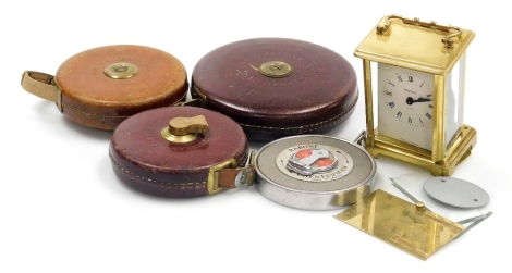 A Chesterman Constantia 100 foot tape measure, 66 foot tape measure, 50 foot tape measure and a Raybone number 70W 50 foot tape measure, together with a Bayard eight day carriage clock. (5, AF)