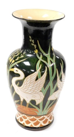 A Chinese Republic pottery vase, sgraffito decorated with cranes and reeds, 52cm high.