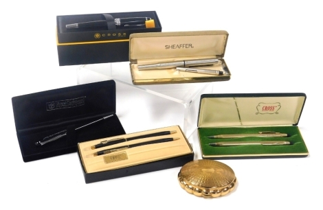 A group of Cross ballpoint pens, to include a Cross Cunard black and steel cased pen, boxed, a pair of Cross Weston Gear Corporation ballpoint pens, boxed, various other examples, and a mid century powder compact. (1 tray)