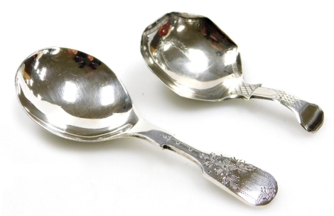 A Victorian silver Fiddle pattern caddy spoon, the handle with bright cut floral decoration, Sheffield 1856, and a Georgian silver caddy spoon, with shaped bowl and bright cut decorated, hallmarks rubbed, 0.81oz.