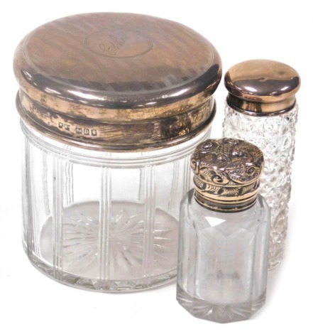 A George V cut glass toilet jar with silver lid, with engine turned decoration, circular reserve engraved Ethel, Mappin & Webb, London 1917, Victorian cut glass smelling salts bottle, with silver mount and hinged lid, embossed with leaves and scrolls, Mil