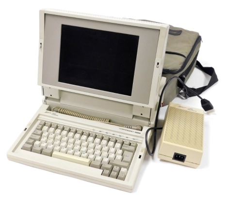 A Zenith Data Systems Turbos port 386 laptop, with charging battery, cable, and carry bag.